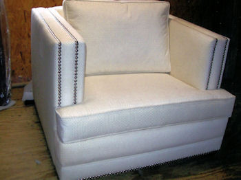 White easy chair upholstered with vinyl upholstery fabric