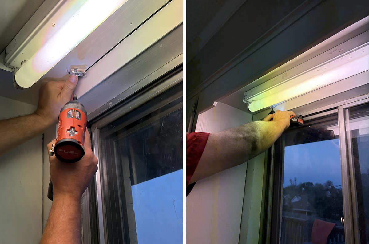 Screwing a roller shade bracket into the top of a wood window frame, marked with painter's tape